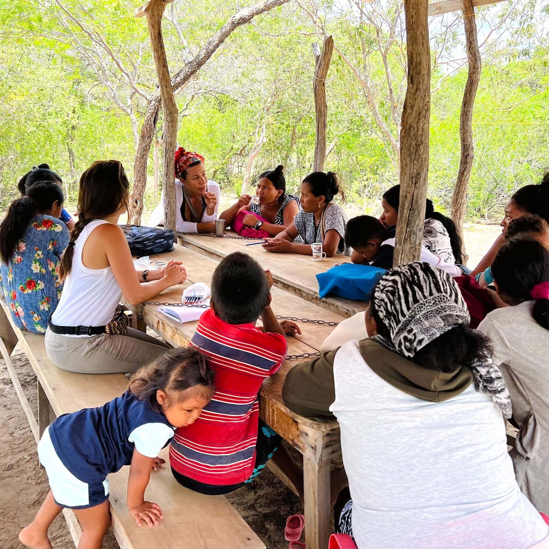 Community meeting with Wayuu women and children in a traditional "enramada"