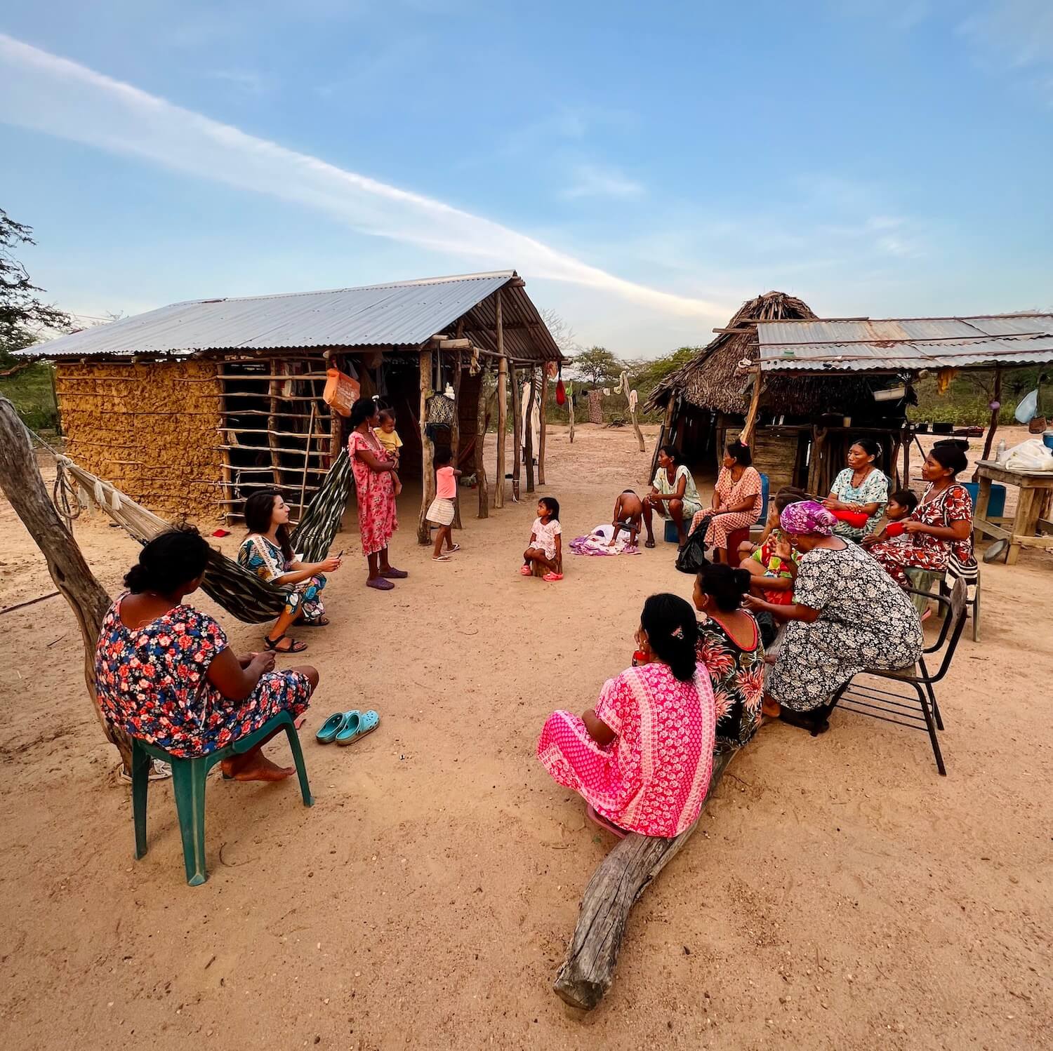Group of women sitting in a circle in a traditional Wayuu village