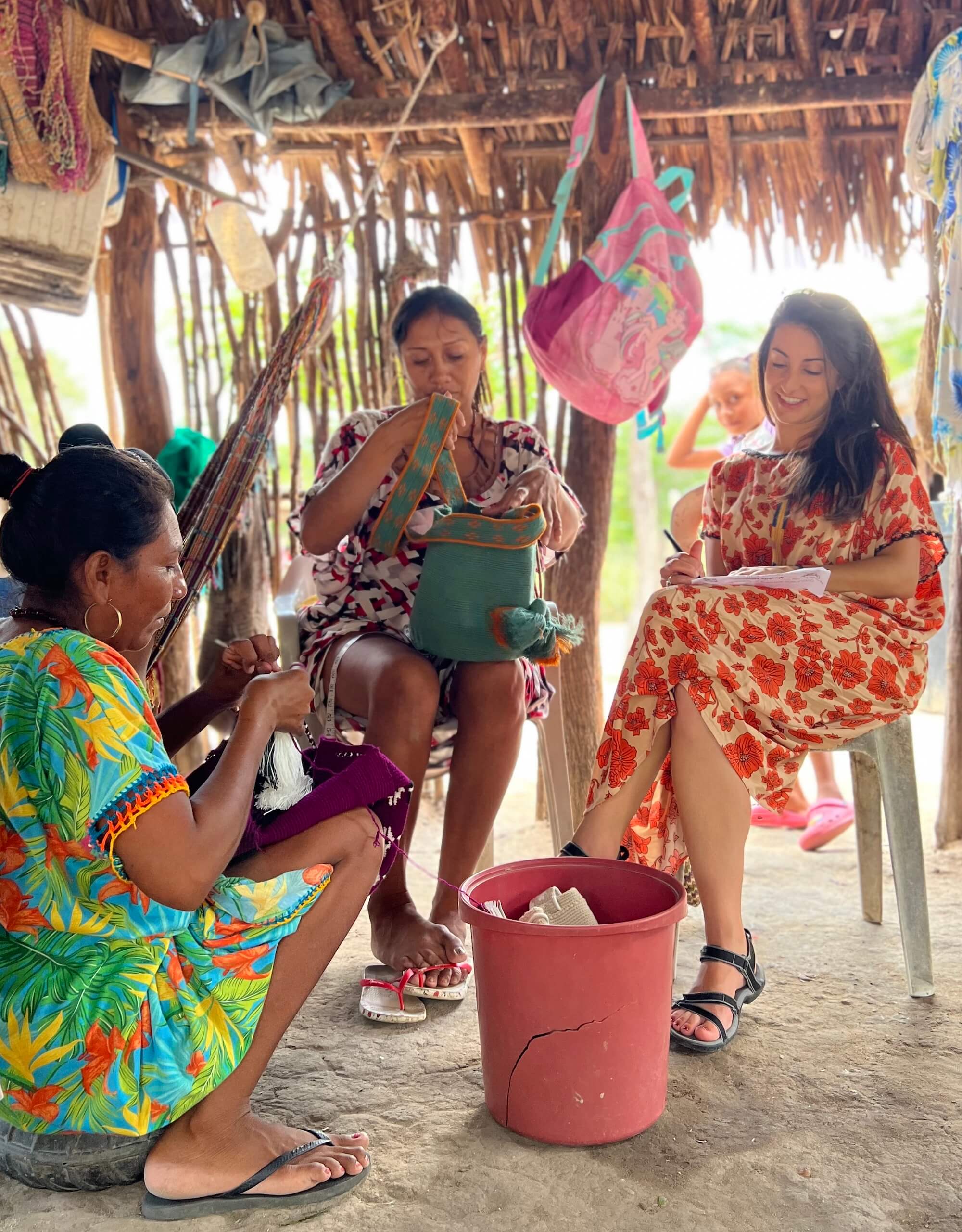 Women sitting and talking in a traditional Wayuu kitchen