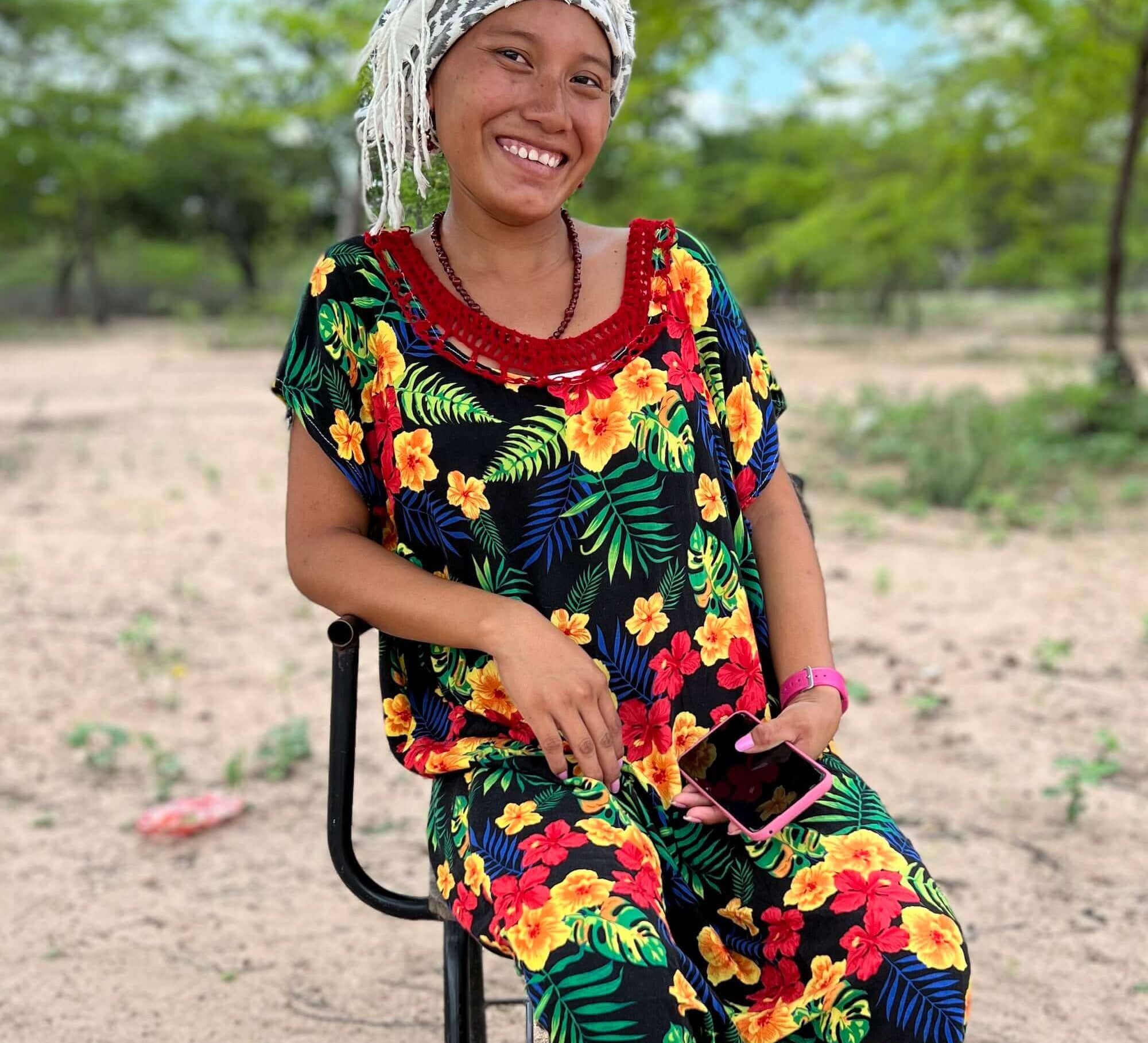 Wayuu woman in colourful "manta" dress and headscard in a rural village