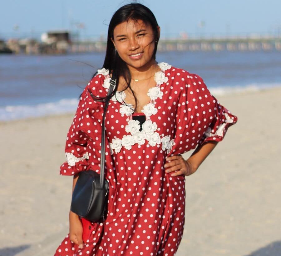 Young Wayuu woman in a traditional "manta" dress on the beach