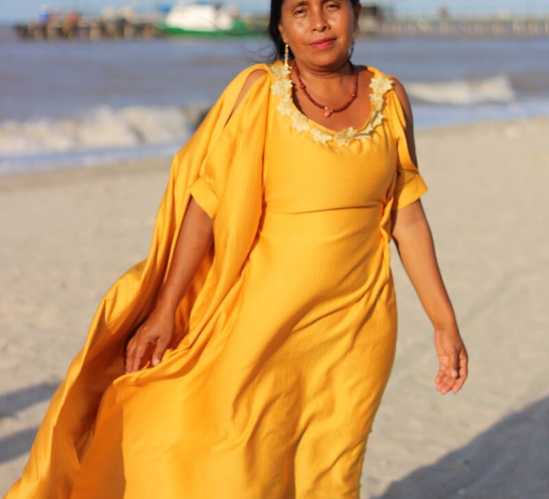 Wayuu women in a traditional "manta" dress on the beach