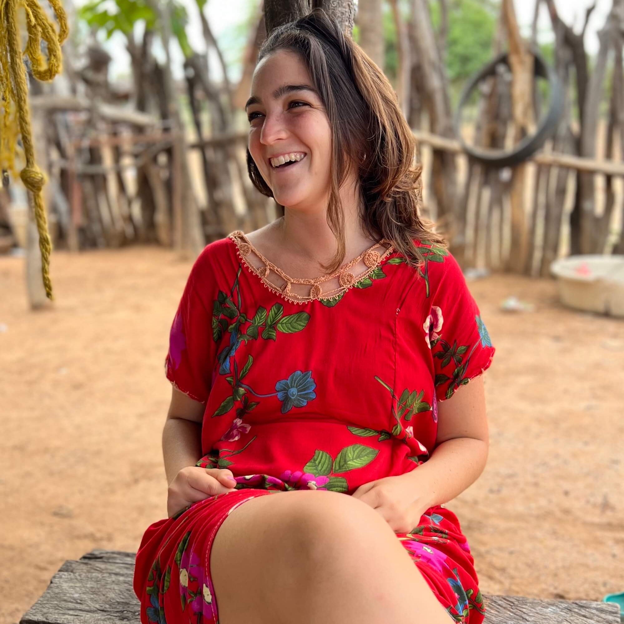 Young woman laughing in a traditional Wayuu "manta" dress in a Wayuu village