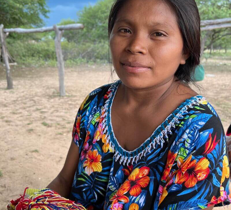 Wayuu women in a colourful "manta" dress in a rural village