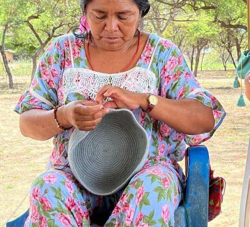 Wayuu woman crocheting a traditional crossbody mochila bag