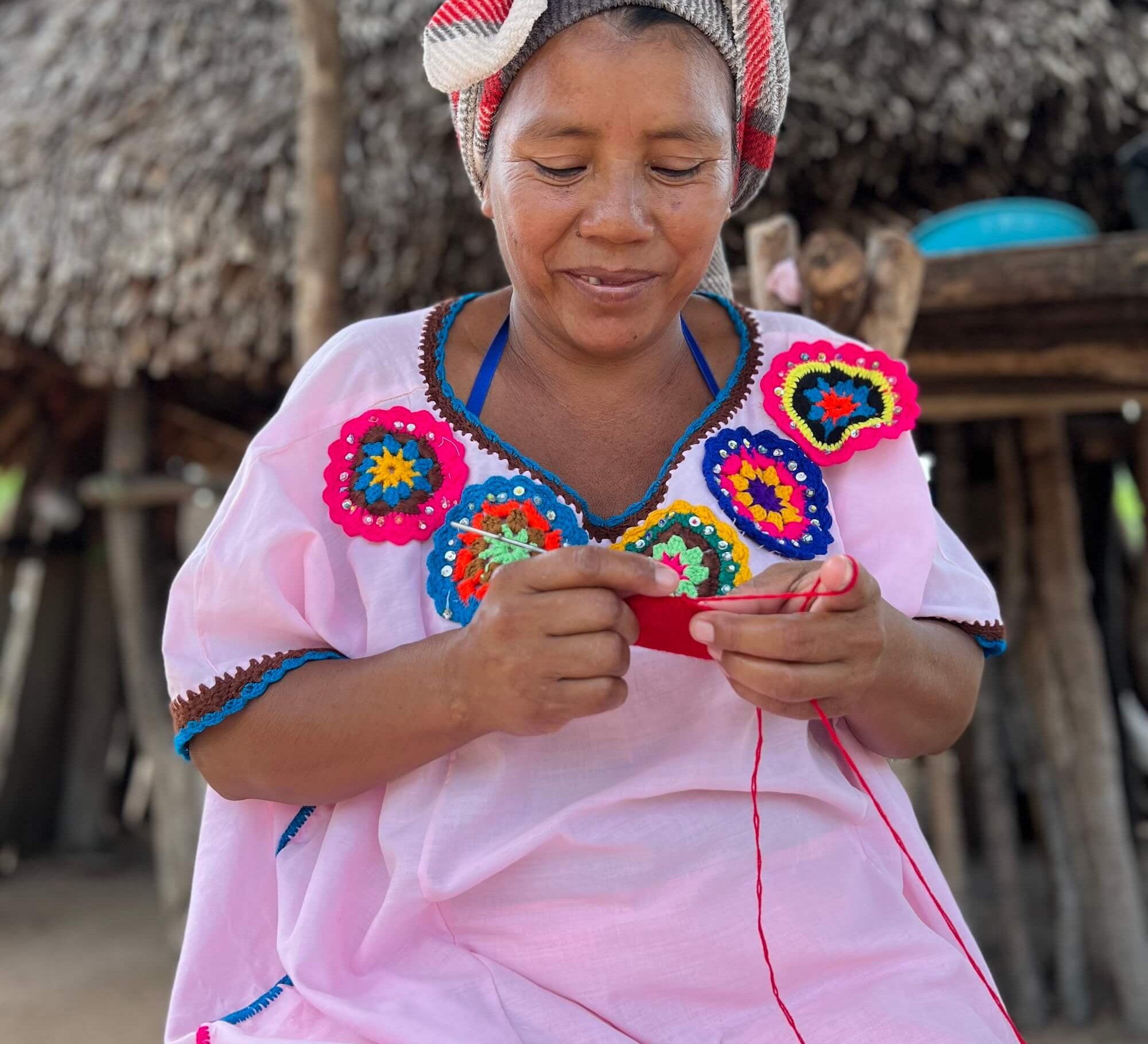 Wayuu woman in colourful "manta" dress and headscarf in a rural village