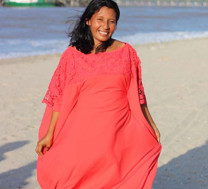 Wayuu woman in a traditional "manta" dress on the beach