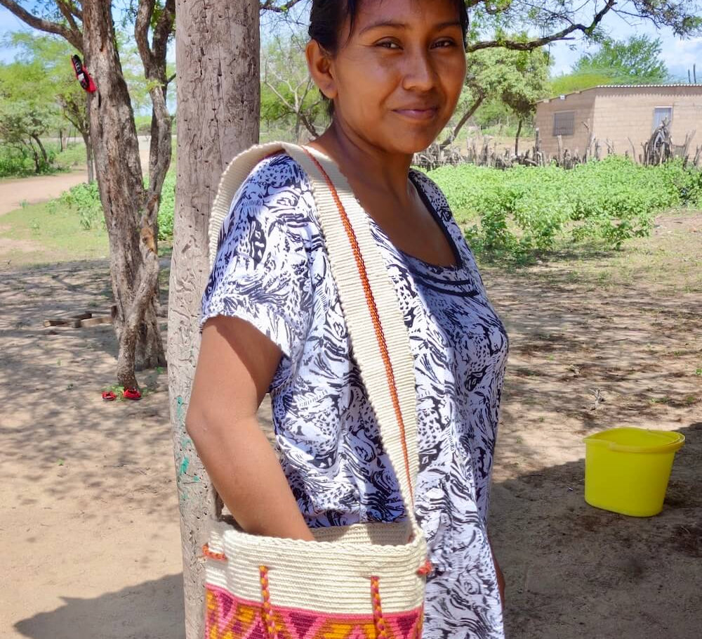 Wayuu woman wearing a crossbody mochila bag in a rural village